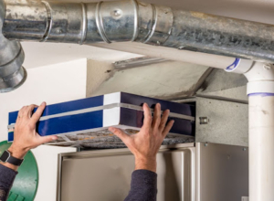 Technician replacing a furnace filter