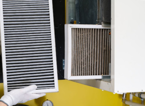 Replacing a dirty air filter with a new one.