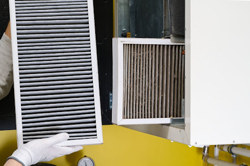 Replacing a dirty air filter with a new one.